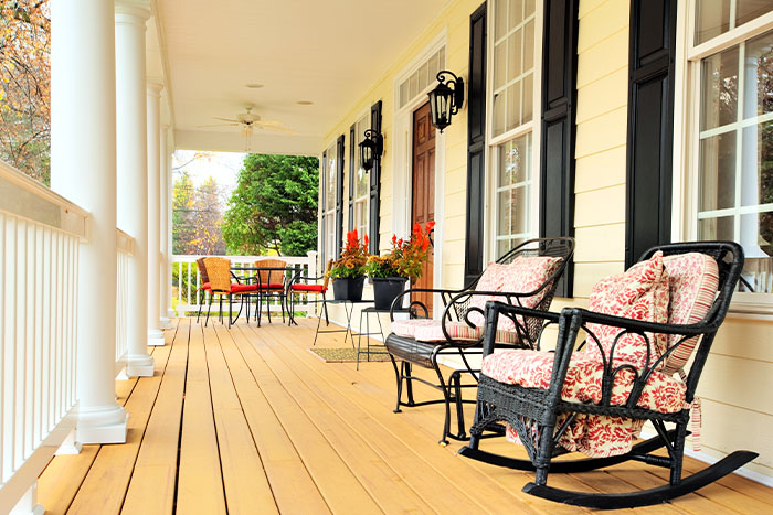 Long front porch displaying beautiful round white columns